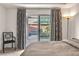 The bedroom provides outside views of a pool area, as seen through the large sliding glass doors at 6276 Olde Lockford Ct, Las Vegas, NV 89139
