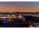 Enjoy city lights and mountain views from this elevated neighborhood vantage point at twilight at 6276 Olde Lockford Ct, Las Vegas, NV 89139