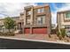 Contemporary two-story home boasting stone and stucco siding, with a three-car garage and landscaped front yard at 6276 Olde Lockford Ct, Las Vegas, NV 89139