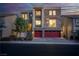 Well-lit modern two-story home with stone accents, two-car garage, and manicured front yard at 6276 Olde Lockford Ct, Las Vegas, NV 89139