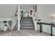 Bright foyer with modern staircase, sleek console table, and views of the pool at 6276 Olde Lockford Ct, Las Vegas, NV 89139