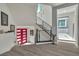 Hallway with a modern staircase and a vibrant red accent door at 6276 Olde Lockford Ct, Las Vegas, NV 89139