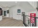 Hallway with modern railings, bright walls with art, and light wood-look floors at 6276 Olde Lockford Ct, Las Vegas, NV 89139