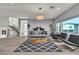 Bright living room features modern decor, stylish lighting, and large windows that provide ample natural light at 6276 Olde Lockford Ct, Las Vegas, NV 89139