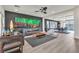 Spacious living room with sleek furniture, stylish rug, and seamless flow to dining area at 6276 Olde Lockford Ct, Las Vegas, NV 89139
