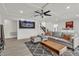 Inviting living room with a large sectional sofa, modern decor, and staircase in view at 6276 Olde Lockford Ct, Las Vegas, NV 89139