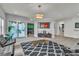 Bright, modern living area with comfortable seating, glass-top coffee table, and access to an outdoor patio, ideal for relaxation at 6276 Olde Lockford Ct, Las Vegas, NV 89139