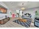 Spacious living room with stylish decor, modern furnishings, neutral tones, and hardwood floors, creating an inviting, open space at 6276 Olde Lockford Ct, Las Vegas, NV 89139