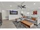 Bright living room with a stylish gray sofa, recessed lighting, and access to other rooms at 6276 Olde Lockford Ct, Las Vegas, NV 89139