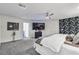 Bright main bedroom features a decorative wall, TV, carpeting and ample space at 6276 Olde Lockford Ct, Las Vegas, NV 89139