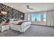 Spacious main bedroom with striking accent wall, plush gray carpeting and ample natural light at 6276 Olde Lockford Ct, Las Vegas, NV 89139