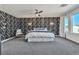 Spacious main bedroom with striking accent wall, plush gray carpeting and ample natural light at 6276 Olde Lockford Ct, Las Vegas, NV 89139