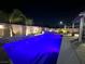Backyard pool and spa with exterior lighting, at night at 6276 Olde Lockford Ct, Las Vegas, NV 89139