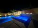 Backyard pool with spa and fire feature at night at 6276 Olde Lockford Ct, Las Vegas, NV 89139