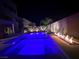 Sparkling backyard pool and spa, beautifully illuminated at night at 6276 Olde Lockford Ct, Las Vegas, NV 89139