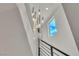 Modern chandelier hanging above the staircase with natural light and a view of the sky at 6276 Olde Lockford Ct, Las Vegas, NV 89139