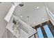 The staircase has a modern hanging light fixture and two tall trapezoid windows at 6276 Olde Lockford Ct, Las Vegas, NV 89139