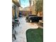 Backyard patio with artificial turf and seating area at 6687 Keyesport Ct, Las Vegas, NV 89148