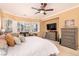 Bright main bedroom with a ceiling fan, sitting area, and neutral decor at 6886 Barred Dove Ln, North Las Vegas, NV 89084