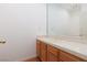 Bright bathroom with wood vanity and large mirror at 7520 W Wigwam Ave, Las Vegas, NV 89113