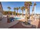 Relaxing kidney shaped pool with surrounding patio and palm trees at 7520 W Wigwam Ave, Las Vegas, NV 89113