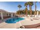 Beautiful kidney-shaped pool with ample patio space and palm trees at 7520 W Wigwam Ave, Las Vegas, NV 89113