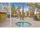 Relaxing pool and spa area with palm trees and lounge chairs at 7950 W Flamingo Rd # 1054, Las Vegas, NV 89147