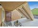 Exterior condo entry with stairs, seating, and small cactus plant at 7950 W Flamingo Rd # 1054, Las Vegas, NV 89147