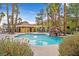 Community pool with a rock waterfall feature at 7950 W Flamingo Rd # 1054, Las Vegas, NV 89147