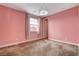 Pastel pink bedroom with window and decorative chandelier at 8372 Brimson St, Las Vegas, NV 89148