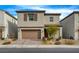 Two-story house with brown garage door and landscaping at 8372 Brimson St, Las Vegas, NV 89148