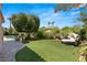 Landscaped backyard with a large grassy area at 9113 Golden Eagle Dr, Las Vegas, NV 89134