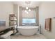 Elegant bathroom with soaking tub, modern vanity, and tile accents at 9113 Golden Eagle Dr, Las Vegas, NV 89134