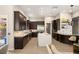 Modern kitchen with dark cabinetry, marble countertops, and stainless steel appliances at 9113 Golden Eagle Dr, Las Vegas, NV 89134