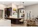 Modern kitchen with dark wood cabinetry and a large island at 9113 Golden Eagle Dr, Las Vegas, NV 89134