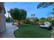 Expansive grassy yard with pool and relaxing daybed at 9113 Golden Eagle Dr, Las Vegas, NV 89134