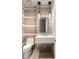 Elegant powder room with a floating vanity and designer tile at 9113 Golden Eagle Dr, Las Vegas, NV 89134