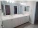 Bathroom featuring double sink vanity with white cabinets, countertop, and modern fixtures at 927 Via Canale Dr, Henderson, NV 89011