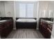 Bathroom showcases a large soaking tub, granite countertops, and dark wood cabinets at 927 Via Canale Dr, Henderson, NV 89011