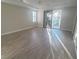 Bright bedroom with wood floors, plantation shutters, and a sliding glass door to the balcony at 927 Via Canale Dr, Henderson, NV 89011