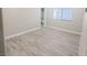 Bedroom with light wood flooring, white trim, and a view into an ensuite bathroom at 927 Via Canale Dr, Henderson, NV 89011