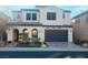Two-story house with a gray door and landscaping at 927 Via Canale Dr, Henderson, NV 89011