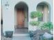 Home features arched entryway, wood door, and potted plants at 927 Via Canale Dr, Henderson, NV 89011