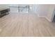 Upstairs hallway features light wood flooring, white baseboards, and black decorative railing at 927 Via Canale Dr, Henderson, NV 89011