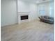 Bright living room featuring shiplap accent wall, fireplace with stone accents, and modern flooring at 927 Via Canale Dr, Henderson, NV 89011