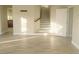 Living room featuring wood-look floors leading to the staircase, hallway, and doorway at 927 Via Canale Dr, Henderson, NV 89011