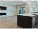 Open living space with a fireplace, kitchen island, and sliding glass doors to outdoor area at 927 Via Canale Dr, Henderson, NV 89011