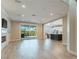 Bright living room featuring a fireplace and open access to a modern kitchen and outdoor views at 927 Via Canale Dr, Henderson, NV 89011