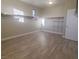 Spacious walk-in closet with wood flooring, white trim, and adjustable shelving at 927 Via Canale Dr, Henderson, NV 89011
