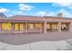 Back of house with covered patio, gravel yard, and windows that offer bright natural light to the interior at 9609 Eagle Valley Dr, Las Vegas, NV 89134